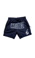 Front view of the basketball shorts with white weediez logo on center and embroidered “w” on left side leg