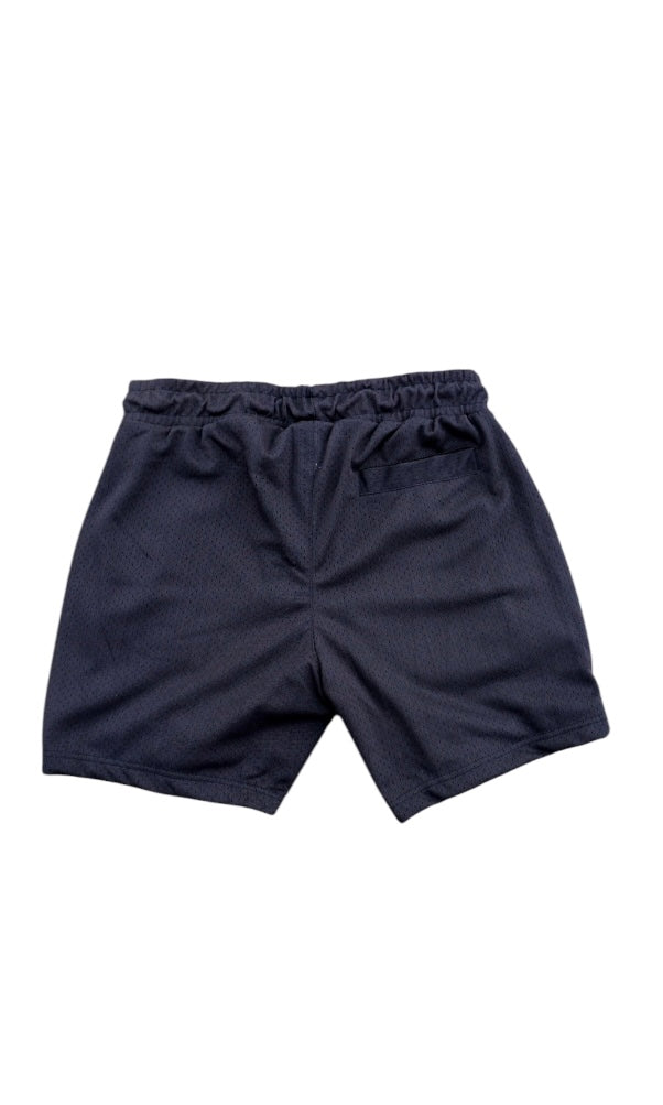 Front view of the basketball shorts with white weediez logo on center and embroidered “w” on left side leg