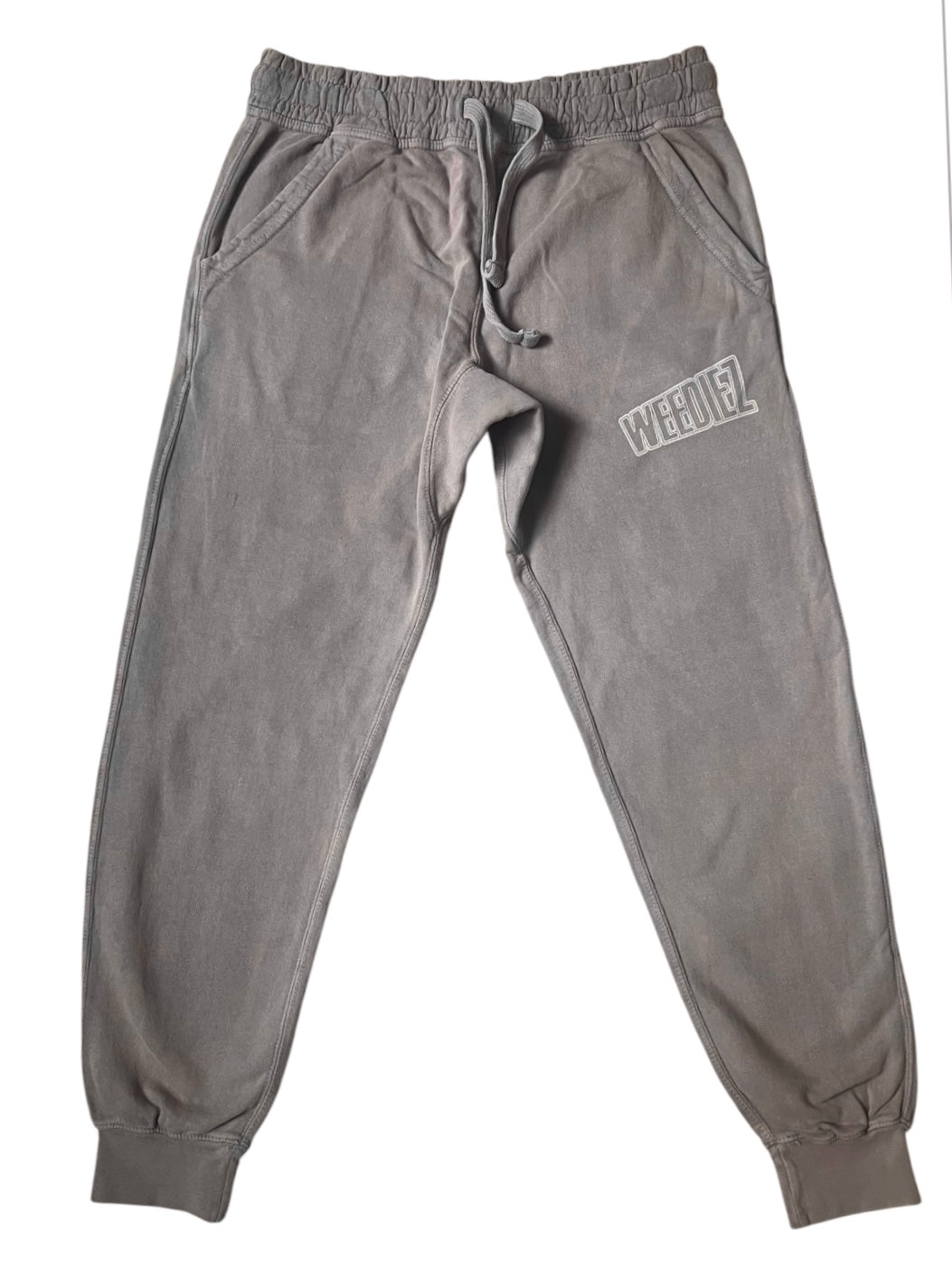 Front view of the grey signature style joggers with a off-white Weediez colored logo